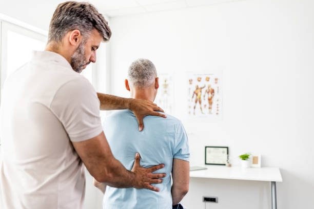 Doctor with patient physiotherapy clinic