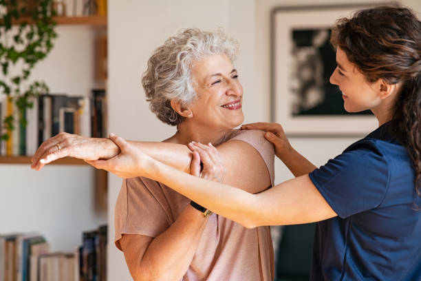 Young physiotherapist helping patient with back problems